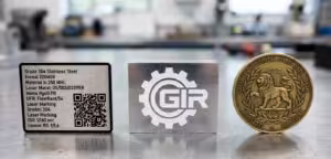 Comparison of fiber laser power settings on three metals: black marking on stainless steel, white engraving on aluminum, and deep relief on a brass coin.