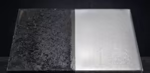 Side-by-side comparison of an industrial metal plate: left side shows heavy mill scale and lubricant contamination; right side shows clean metallic surface after Laser Surface Prep for improved welding and bonding.